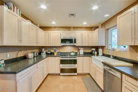 Check out our kitchen sinks. Light birch cabinets, dark countertop - paint color help ...