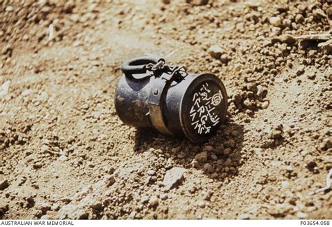 An Unexploded Hand Grenade Lying On The Ground Prior To Its Disposal By