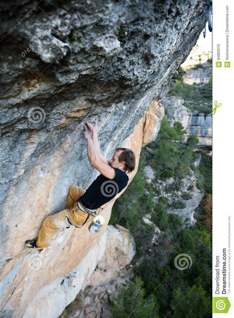 Rock Climber Professional Athlete Climbing A Steep Cliff Extreme