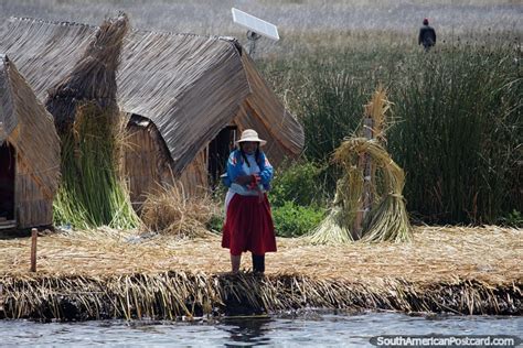 The Uros People Live On Floating Reed Islands At Lake Titicaca A Woman Outside Thatched Houses