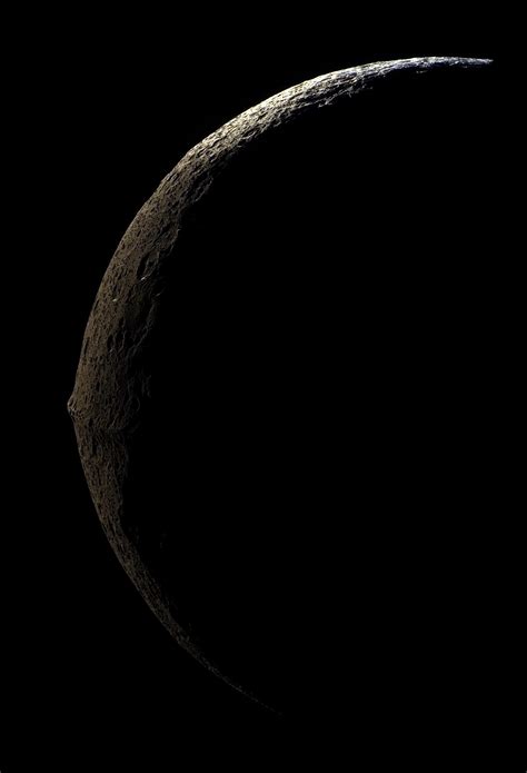 Iapetus Side View The Slim Crescent Of Iapetus Looms Before The Cassini