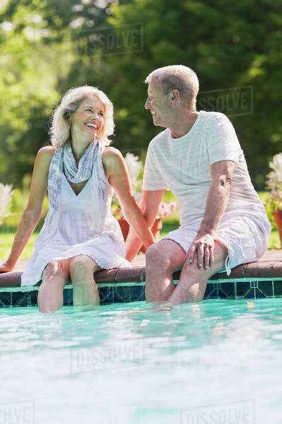 Senior Couple At Edge Of Swimming Pool Stock Photo Dissolve