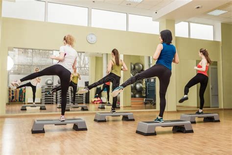 Group Of Women Making Step Aerobics From The Backside Stock Image