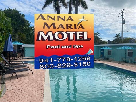 A Hotel Sign Is In Front Of A Swimming Pool