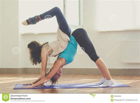 Hope you guys enjoy watching it as. Two Slim Girls Are Doing Yoga Indoors Stock Photo - Image ...