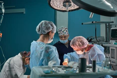 Group Of Surgeons In Operating Theater Medical Team Performing Surgery