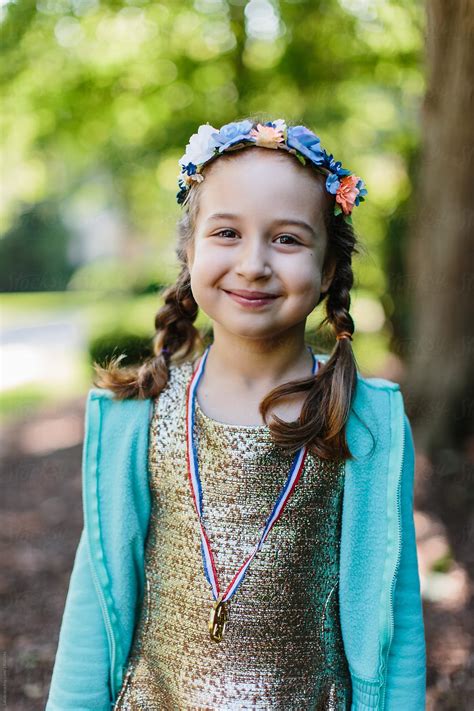 Portrait Of A Beautiful Young Girl Wearing A Medal Around Her Neck By