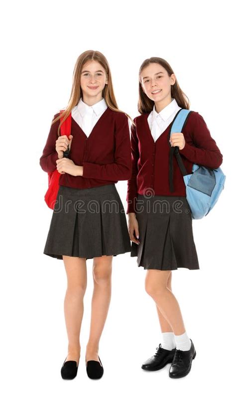 Full Length Portrait Of Teenage Girls In School Uniform On White