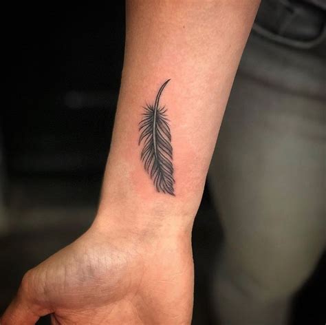 A Small Feather Tattoo On The Wrist