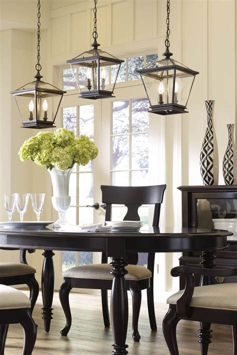 Grouped Lanterns Above A Dining Room Table Add A Contemporary Flair To