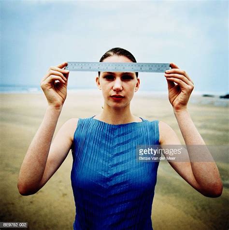 woman holding ruler photos and premium high res pictures getty images