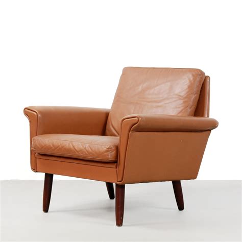 Upholstered with a durable cognac faux leather. Brown cognac leather armchair, Denmark 1960s | #98736