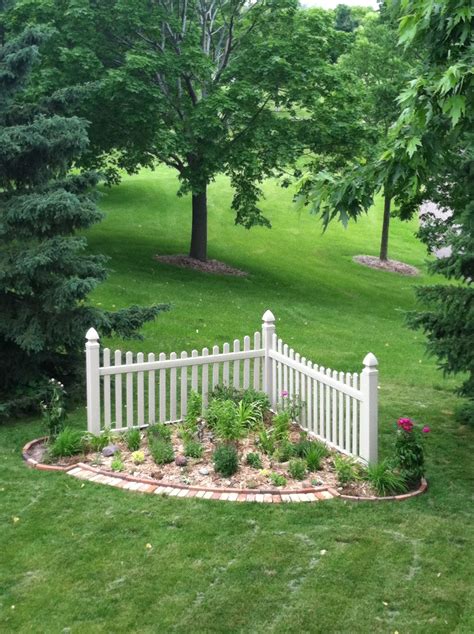 Clear water and beautiful rocks make this garden pond the perfect spot for a family gathering, where kids can hunt for rocks and have fun. Corner Fence garden | Corner landscaping, Front garden landscape, Fence landscaping