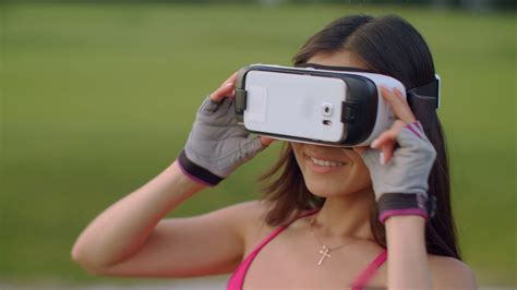 Asian Woman Use Vr Headset In Park Vr Glasses On Woman Head Outdoors
