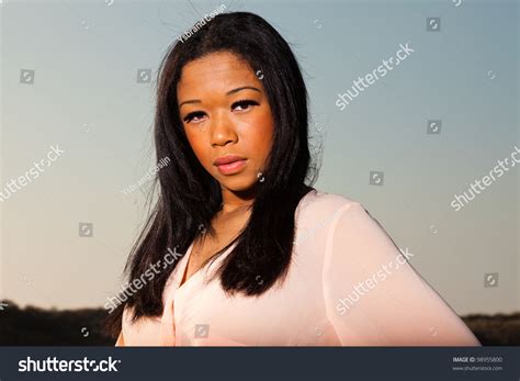 Pretty Young Black Woman Posing In Dune Landscape With Clear Blue Sky