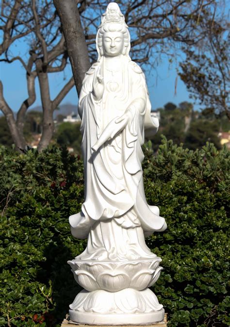 This Statue Of Kwan Yin Is Holding A Vase Of Nectar Which She Is