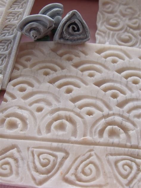 Percussive pods (hand building, carving, sculpting, multiple step process). Detail - The small sculpted stamps made with extruded clay ...