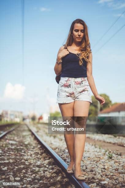 Woman Walking On Train Tracks Stock Photo Download Image Now