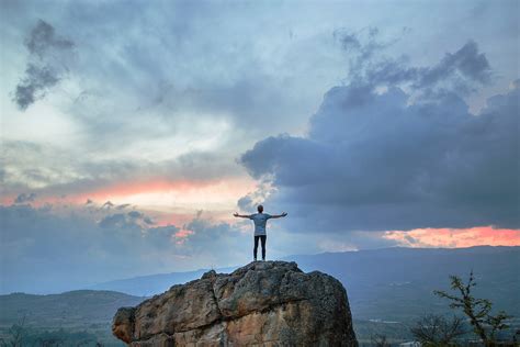 Boy Standing On Mountain Looking At Clouds In Villa De Leyva Image