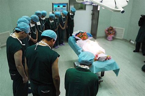 The Medical Staff Of An Organ Donation Operation Bow To Pay Tribute To