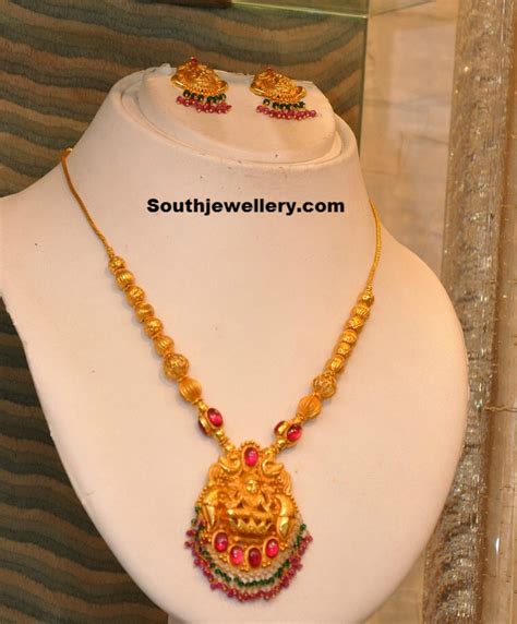 gold necklace with lakshmi pendant indian jewellery designs