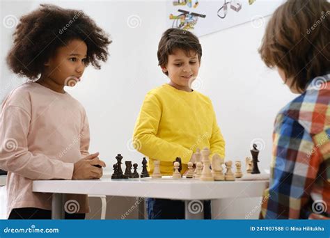 Multiethnic Kids Playing Chess Board Game At School Stock Photo Image