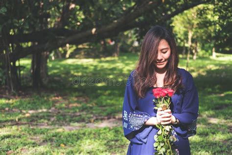 an asian woman holding red roses bouquet with green nature stock image image of girl asian