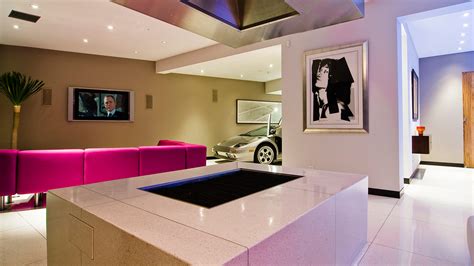 Slab front, dark cherry cabinets with stainless steel accents gives a modern, masculine feel to the kitchen. Modern Hollywood Hills bachelor pad with indoor car park ...