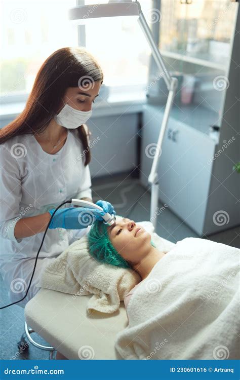 The Cosmetologist Performs A Cosmetic Procedure With Ultrasound