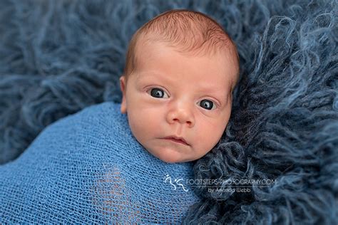 Newborn Baby With Blonde Hair And Blue Eyes