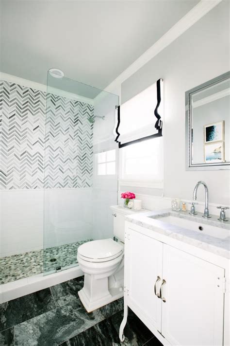 A small boho bathroom clad with white subway tiles, with black and white penny ones, with lots of plants for a forest feel. Gray Small Bathroom With Glass Shower | HGTV