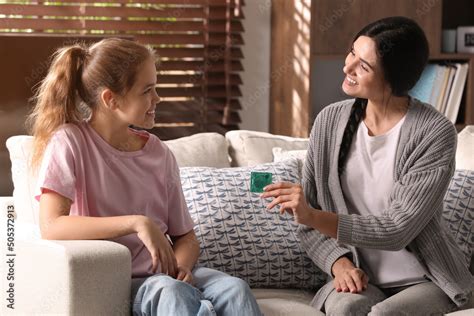 Mother Talking With Her Teenage Daughter About Contraception At Home