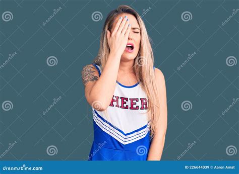 Young Beautiful Blonde Woman Wearing Cheerleader Uniform Yawning Tired