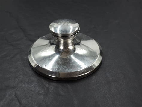 A George V Silver Capstan Inkwell Of Flared Circular Form With Hinged