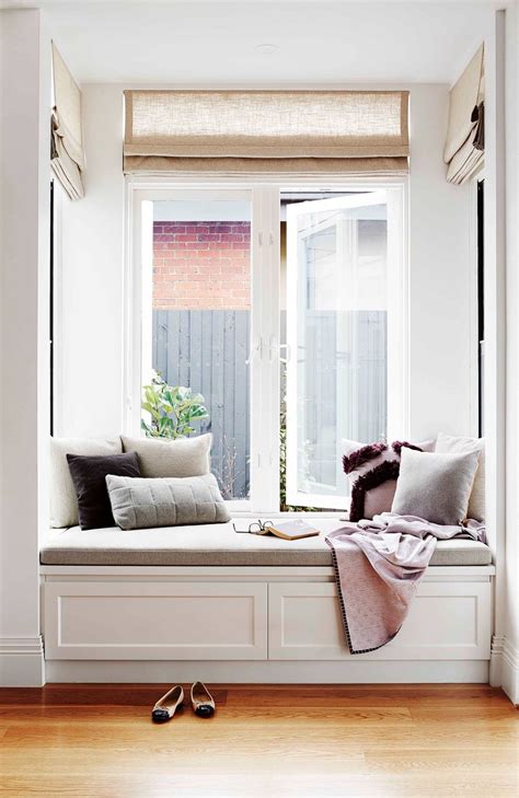 Great ideas for your attic bedroom decorating. White built in window seat with grey cushion and storage ...