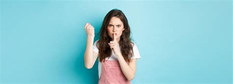 Serious And Angry Brunette Girl Shaking Fist And Frowning With
