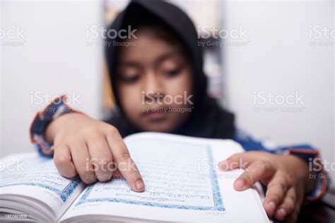 Little Muslim Girl In Hijab Reads Quran Stock Photo Download Image