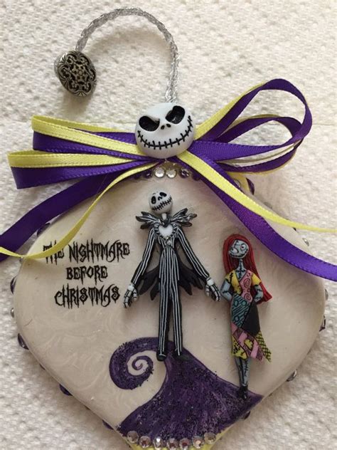 The Nightmare Before Christmas Ornament Is Hanging From A Purple Ribbon