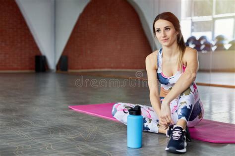 Sport Woman Sitting And Resting After Workout Or Exercise In Fitness