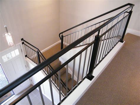 Wood And Iron Railing Curb Mounted On Stair Riser Allows For An Open