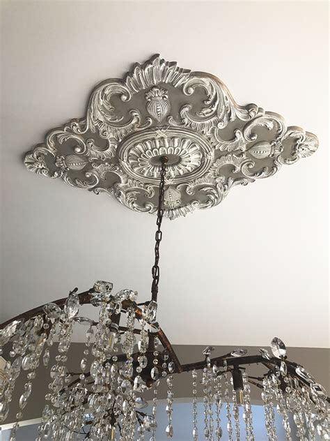 Ceiling medallions are decorative disks that are attached to the base of a ceiling lighting fixture. Beautiful Ekena Millwork Ceiling Medallion with a ...