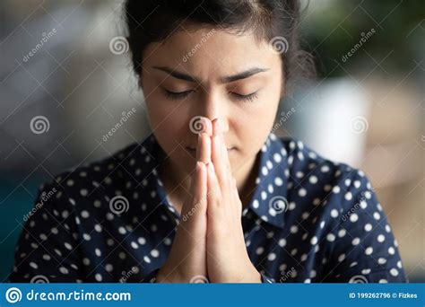 Closeup Religious Indian Female Closed Eyes Praying With Folded Palms
