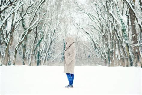 Young Woman Walking In Snowy Winter Park Winter Concept Stock Photo