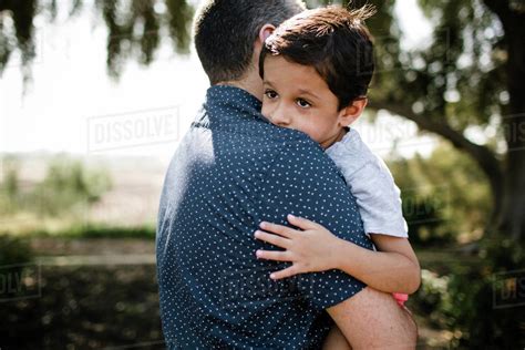 One of many great free stock photos from pexels. Autistic Boy Hugging Dad While Standing Under Tree - Stock ...