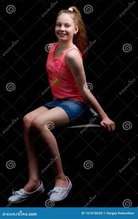 A Teenage Girl Is Sitting On A Leather Chair Stock Photo Image Of