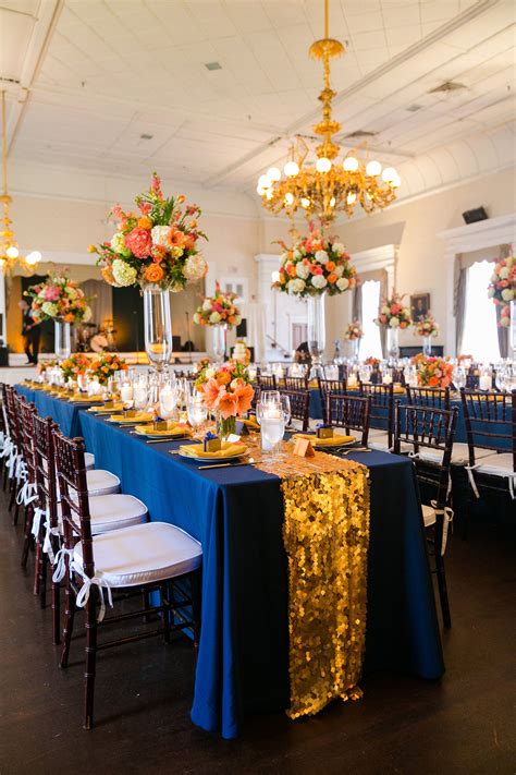 Gold sequin table runners on long banquet tables. Navy, orange, and