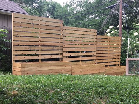 The prefab wood panels require a total of 6 nails. 8 foot planter box wall 2 feet away from a 6 foot fence