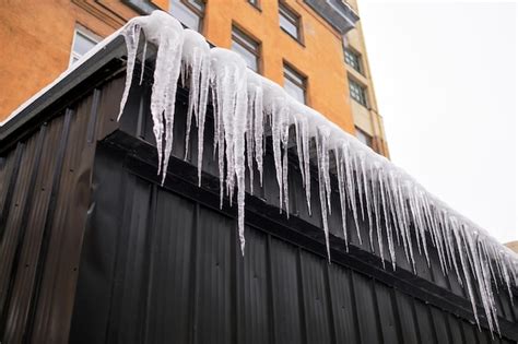 Premium Photo Long Icicles Fall From The Roof On Winter And Early Spring