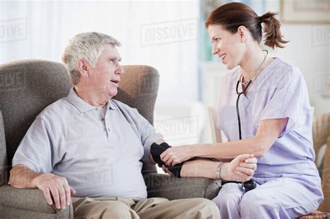Nurse Taking Senior Mans Blood Pressure Stock Photo Dissolve
