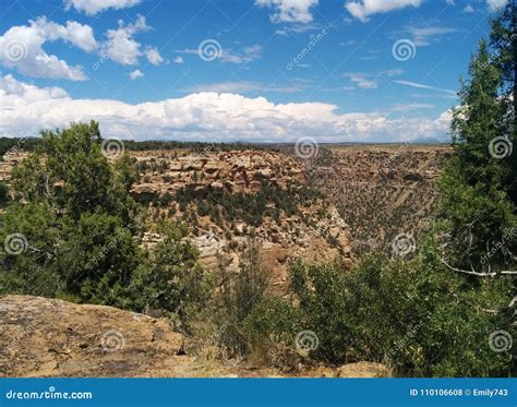 Rocky Desert Valley With Greenery And Clouds In Sky Stock Photo Image